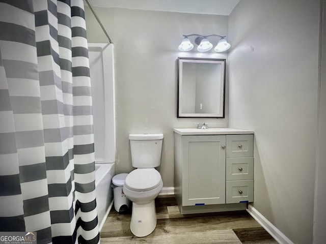 1962 Anderson Rd, Rentz, GA 31075 - bathroom with wood finished floors, vanity, toilet, baseboards, and shower / tub combo