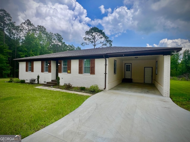 1962 Anderson Rd, Rentz, GA 31075 - ranch-style home with concrete driveway, brick siding, an attached carport, and a front yard