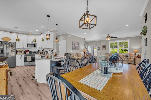 49 Grove Ct, Royston, GA 30662 - dining space featuring a ceiling fan, light wood-type flooring, ornamental molding, recessed lighting, and a chandelier