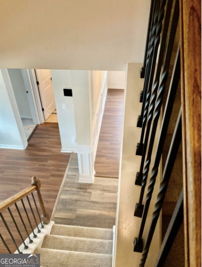 413 Atlas Ct, Locust Grove, GA 30248 - stairway featuring wood finished floors and baseboards