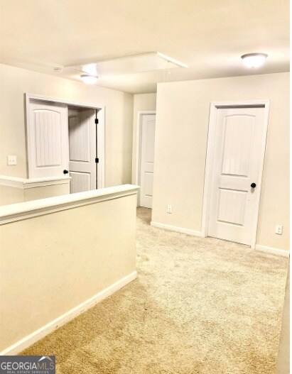 413 Atlas Ct, Locust Grove, GA 30248 - spare room featuring light colored carpet and baseboards