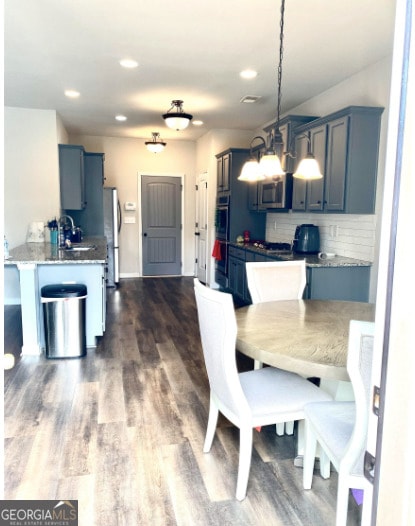 413 Atlas Ct, Locust Grove, GA 30248 - dining room featuring dark wood-style floors, recessed lighting, and baseboards
