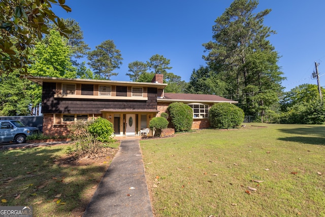 6214 Crestview Dr SE, Covington, GA 30014 - split level home with a chimney, a front yard, and brick siding