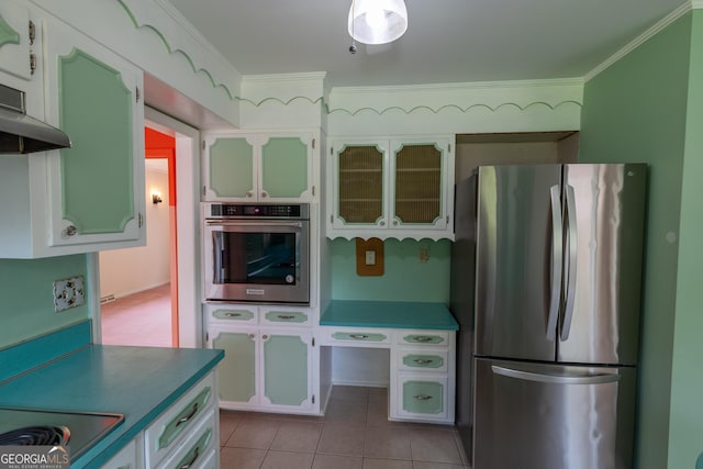 6214 Crestview Dr SE, Covington, GA 30014 - kitchen featuring appliances with stainless steel finishes, ornamental molding, tile patterned floors, exhaust hood, and glass insert cabinets