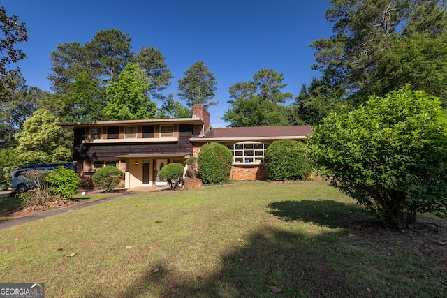 6214 Crestview Dr SE, Covington, GA 30014 - tri-level home featuring a chimney and a front yard