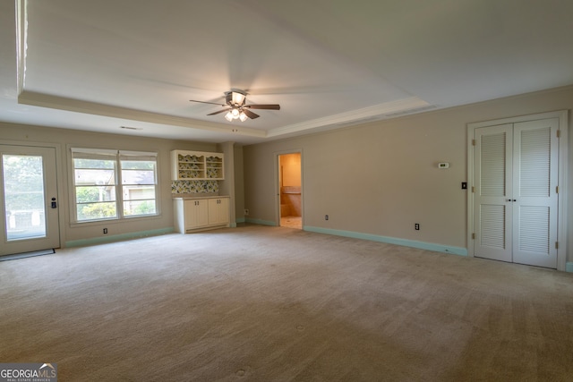 6214 Crestview Dr SE, Covington, GA 30014 - unfurnished room with a raised ceiling, light colored carpet, ceiling fan, baseboards, and ornamental molding