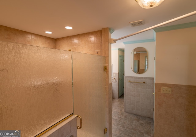 6214 Crestview Dr SE, Covington, GA 30014 - bathroom with tile walls, a stall shower, wainscoting, recessed lighting, and tile patterned flooring