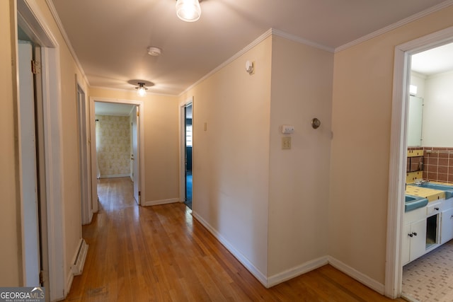 6214 Crestview Dr SE, Covington, GA 30014 - hall featuring light wood-type flooring, crown molding, and baseboards