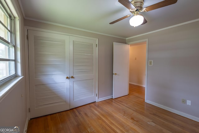 6214 Crestview Dr SE, Covington, GA 30014 - unfurnished bedroom featuring a closet, light wood-type flooring, baseboards, crown molding, and ceiling fan