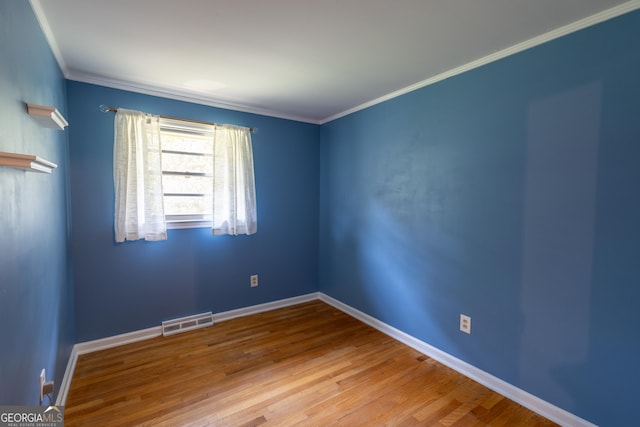 6214 Crestview Dr SE, Covington, GA 30014 - empty room featuring wood finished floors, baseboards, and ornamental molding