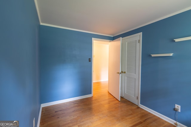 6214 Crestview Dr SE, Covington, GA 30014 - empty room with wood finished floors, baseboards, and ornamental molding