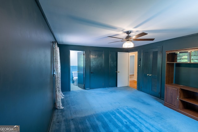 6214 Crestview Dr SE, Covington, GA 30014 - unfurnished bedroom featuring carpet flooring, two closets, connected bathroom, and a ceiling fan