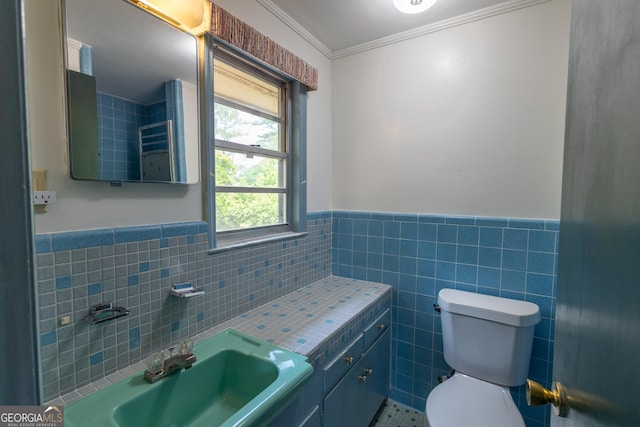 6214 Crestview Dr SE, Covington, GA 30014 - bathroom featuring tile walls, a wainscoted wall, toilet, crown molding, and vanity