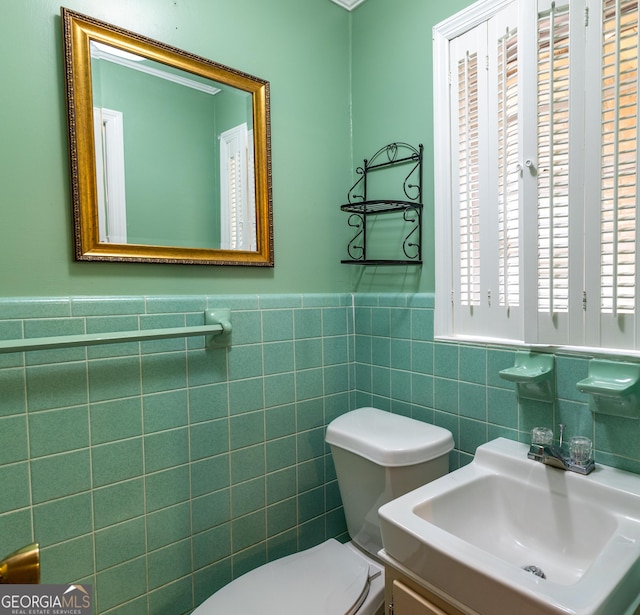 6214 Crestview Dr SE, Covington, GA 30014 - half bath with toilet, tile walls, a wainscoted wall, and vanity