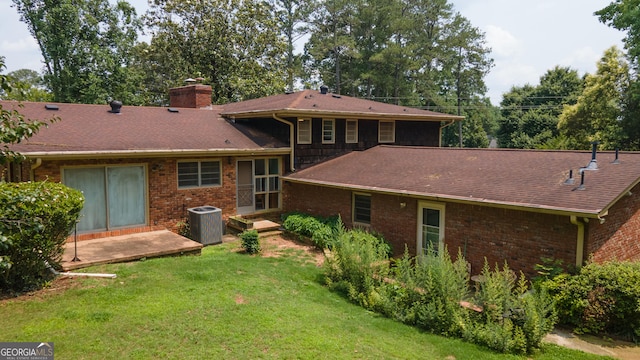 6214 Crestview Dr SE, Covington, GA 30014 - rear view of property with a chimney, central AC unit, a yard, brick siding, and roof with shingles