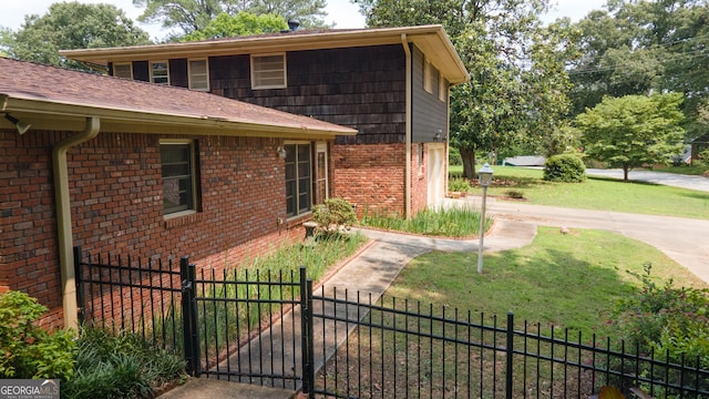 6214 Crestview Dr SE, Covington, GA 30014 - view of side of home featuring brick siding and a gate