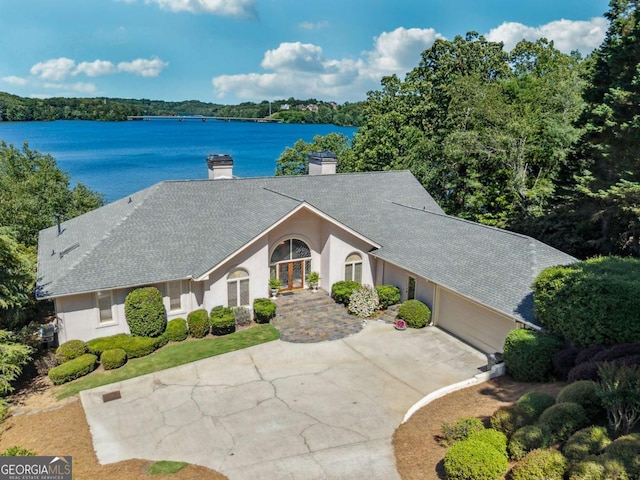 2917 Pointe Dr, Gainesville, GA 30506 - view of front of property with a chimney, a garage, a water view, stucco siding, and driveway