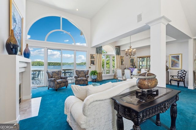 2917 Pointe Dr, Gainesville, GA 30506 - carpeted living room with a chandelier, a high ceiling, and a water view