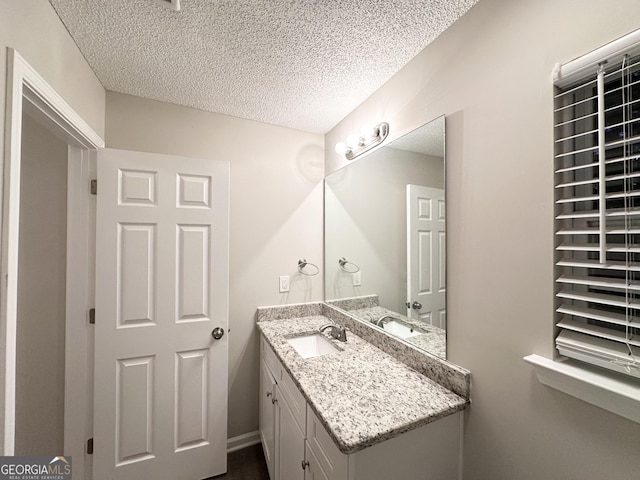 408 Kendall Ln, Mcdonough, GA 30253 - bathroom featuring a textured ceiling and vanity