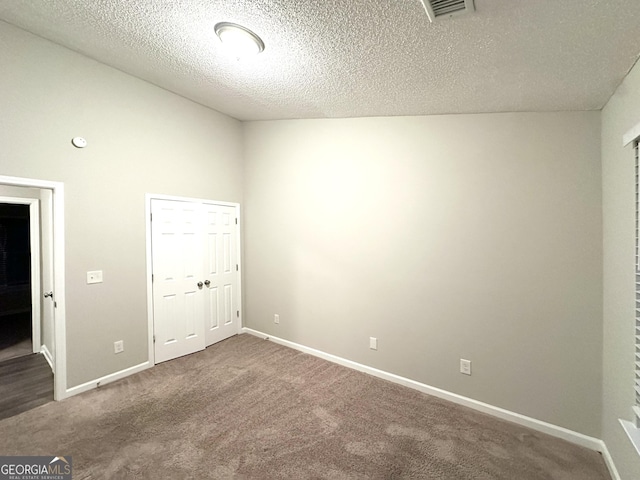 408 Kendall Ln, Mcdonough, GA 30253 - unfurnished bedroom with carpet flooring, a textured ceiling, and baseboards