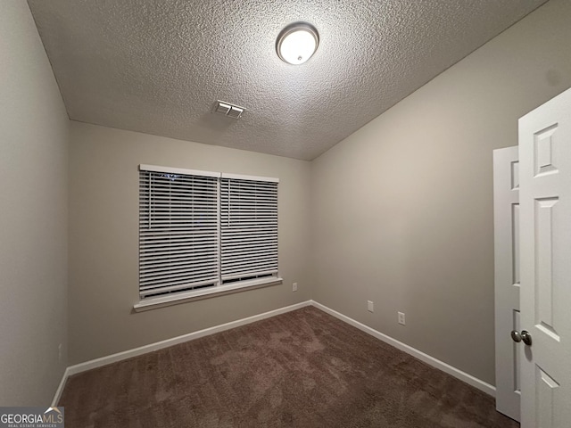 408 Kendall Ln, Mcdonough, GA 30253 - empty room featuring dark carpet, baseboards, and a textured ceiling