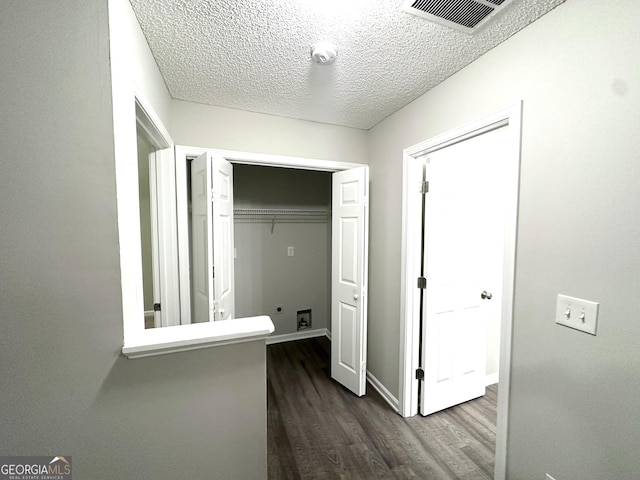 408 Kendall Ln, Mcdonough, GA 30253 - hall featuring dark wood-style flooring, a textured ceiling, and baseboards