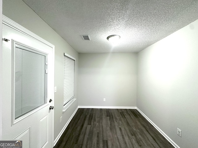 408 Kendall Ln, Mcdonough, GA 30253 - spare room with dark wood finished floors, a textured ceiling, and baseboards