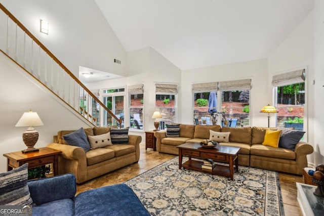 107 W Point Trl, Woodstock, GA 30189 - living area with stairs, high vaulted ceiling, and healthy amount of natural light