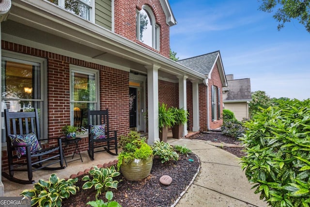 107 W Point Trl, Woodstock, GA 30189 - entrance to property with a porch, brick siding, and roof with shingles