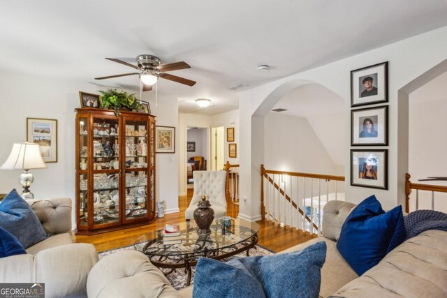 107 W Point Trl, Woodstock, GA 30189 - living room with a ceiling fan, arched walkways, and wood finished floors