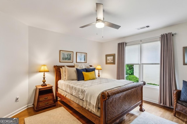 107 W Point Trl, Woodstock, GA 30189 - bedroom with wood finished floors, baseboards, and a ceiling fan