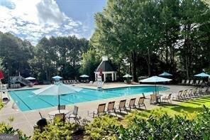 107 W Point Trl, Woodstock, GA 30189 - community pool with a patio and view of scattered trees
