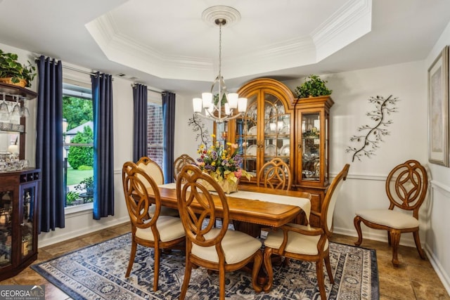 107 W Point Trl, Woodstock, GA 30189 - dining space featuring a chandelier, stone tile floors, a tray ceiling, crown molding, and baseboards