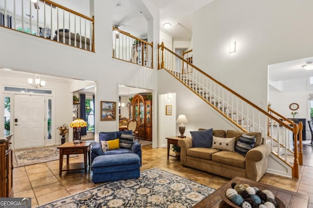 107 W Point Trl, Woodstock, GA 30189 - living area with stairway, a towering ceiling, and ceiling fan