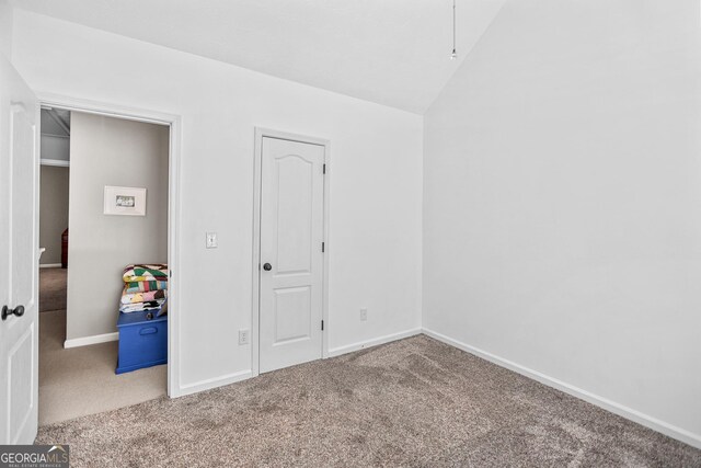 81 Maple Creek Dr, Newnan, GA 30263 - unfurnished bedroom with carpet floors, baseboards, and vaulted ceiling