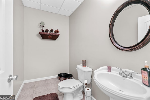 81 Maple Creek Dr, Newnan, GA 30263 - half bathroom featuring a sink, toilet, a paneled ceiling, and baseboards