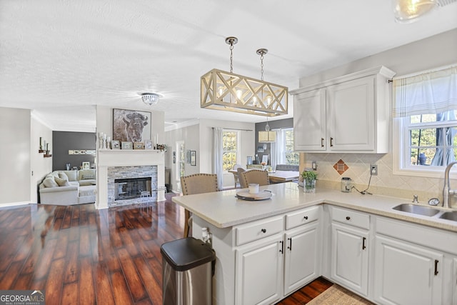 81 Maple Creek Dr, Newnan, GA 30263 - kitchen featuring a sink, dark wood-style floors, white cabinets, light countertops, and decorative backsplash