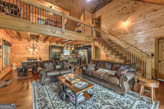 1061 Fir Ln, Ellijay, GA 30540 - living area with wood walls, hardwood / wood-style floors, stairs, a chandelier, and wooden ceiling with exposed beams