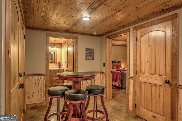 1061 Fir Ln, Ellijay, GA 30540 - dining room featuring a wainscoted wall, wood walls, and wooden ceiling