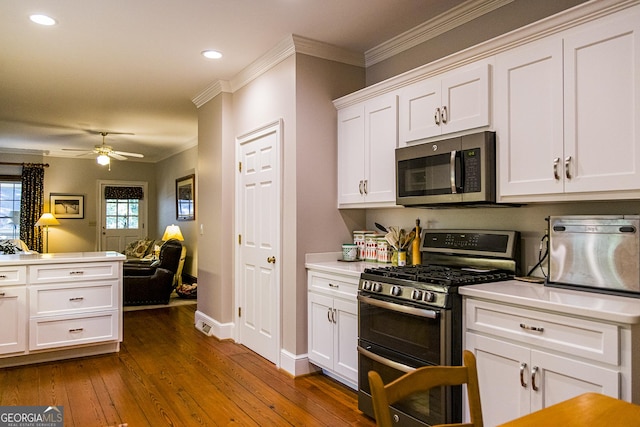 15 Westover Dr SW, Rome, GA 30165 - kitchen featuring stainless steel appliances, ornamental molding, white cabinets, recessed lighting, and dark wood finished floors