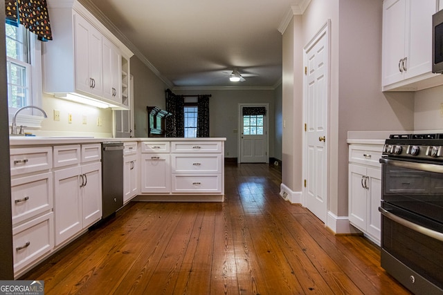 15 Westover Dr SW, Rome, GA 30165 - kitchen with stainless steel appliances, a peninsula, dark wood-style floors, crown molding, and white cabinets