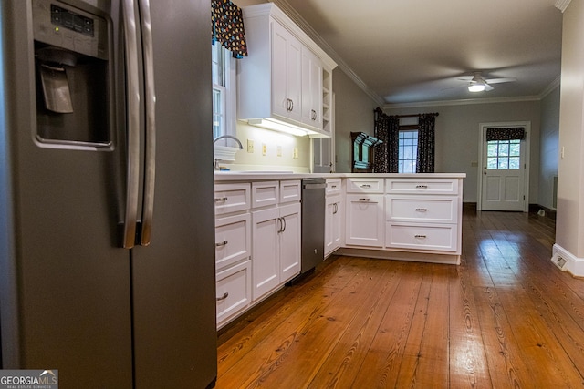 15 Westover Dr SW, Rome, GA 30165 - kitchen featuring appliances with stainless steel finishes, a peninsula, a sink, ornamental molding, and a ceiling fan