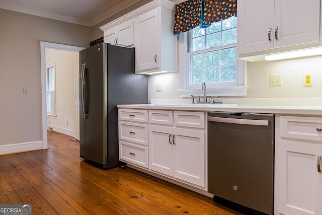 15 Westover Dr SW, Rome, GA 30165 - kitchen featuring appliances with stainless steel finishes, crown molding, white cabinetry, dark wood-style floors, and light countertops