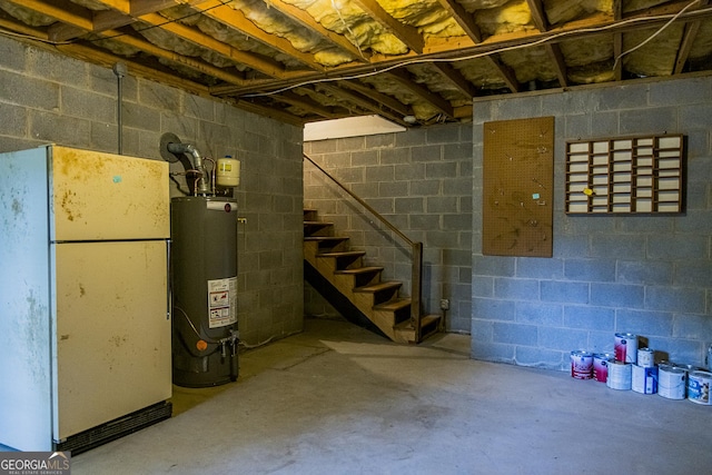 15 Westover Dr SW, Rome, GA 30165 - unfinished basement featuring freestanding refrigerator, gas water heater, and stairway