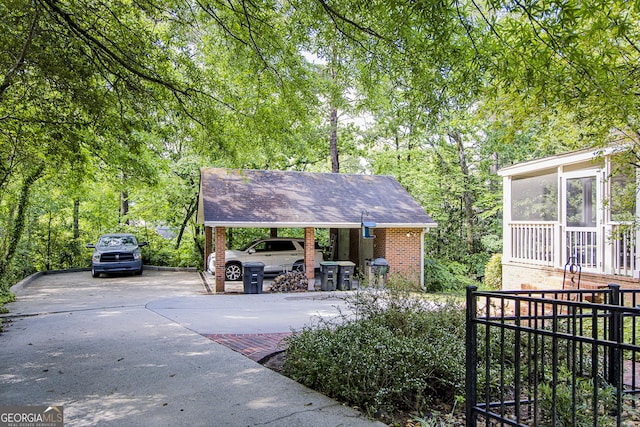15 Westover Dr SW, Rome, GA 30165 - view of front facade with driveway, brick siding, a shingled roof, and a sunroom