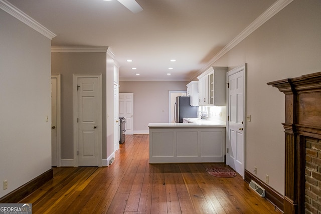 15 Westover Dr SW, Rome, GA 30165 - kitchen with freestanding refrigerator, a sink, dark wood-type flooring, white cabinetry, and a peninsula