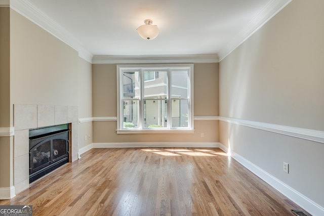 3641 Ridge Towne Dr, Duluth, GA 30096 - unfurnished living room featuring light wood finished floors, a tiled fireplace, and ornamental molding