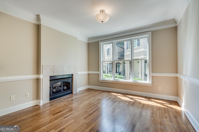 3641 Ridge Towne Dr, Duluth, GA 30096 - unfurnished living room featuring a tiled fireplace, wood finished floors, and ornamental molding