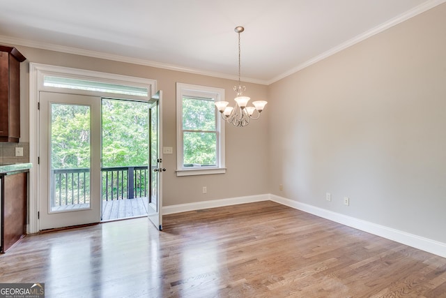 3641 Ridge Towne Dr, Duluth, GA 30096 - unfurnished dining area featuring light wood-style flooring, crown molding, and a chandelier