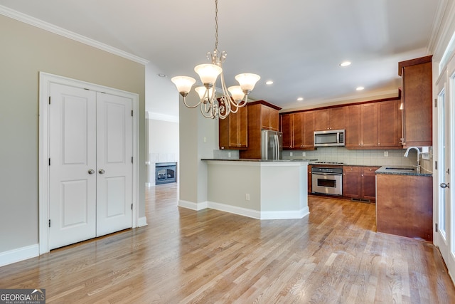 3641 Ridge Towne Dr, Duluth, GA 30096 - kitchen featuring appliances with stainless steel finishes, ornamental molding, a chandelier, tasteful backsplash, and light wood-type flooring